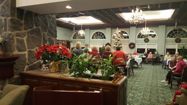 A festive holiday gathering with a beautifully decorated Christmas tree and seasonal decor.