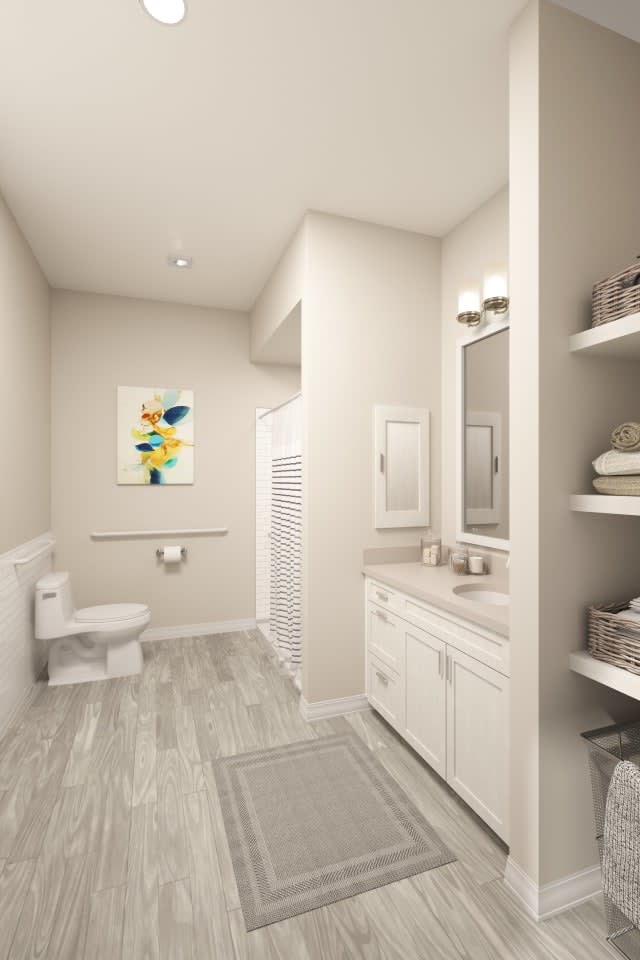 A modern bathroom with white cabinetry and open shelving, featuring a sink, toilet, and wall art.
