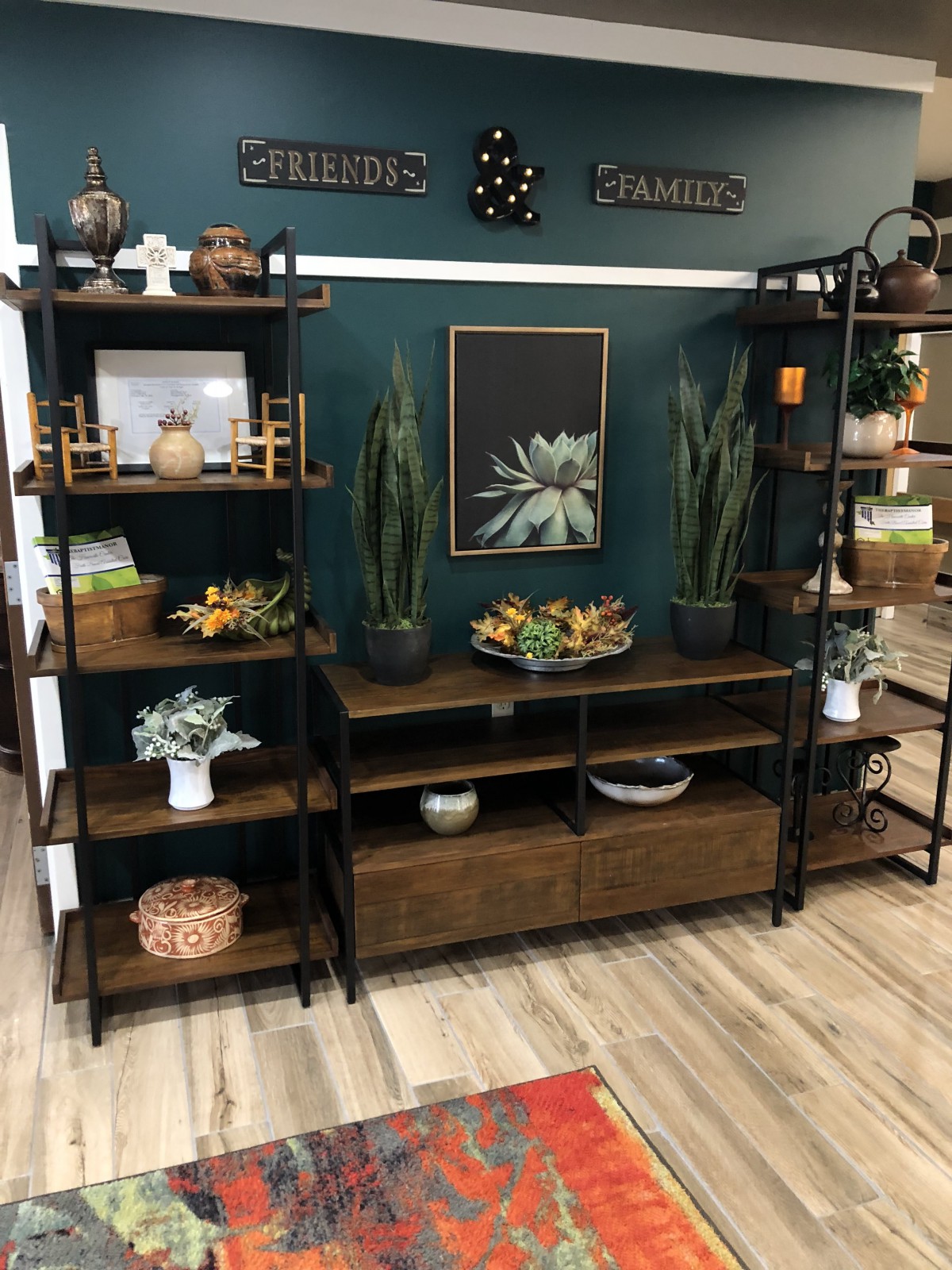 Stylishly arranged wooden shelves with decorative items and plants in a cozy living room setting.