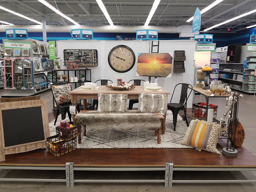 A beautifully arranged display showcasing various furniture and home decor items suitable for a cozy living space.