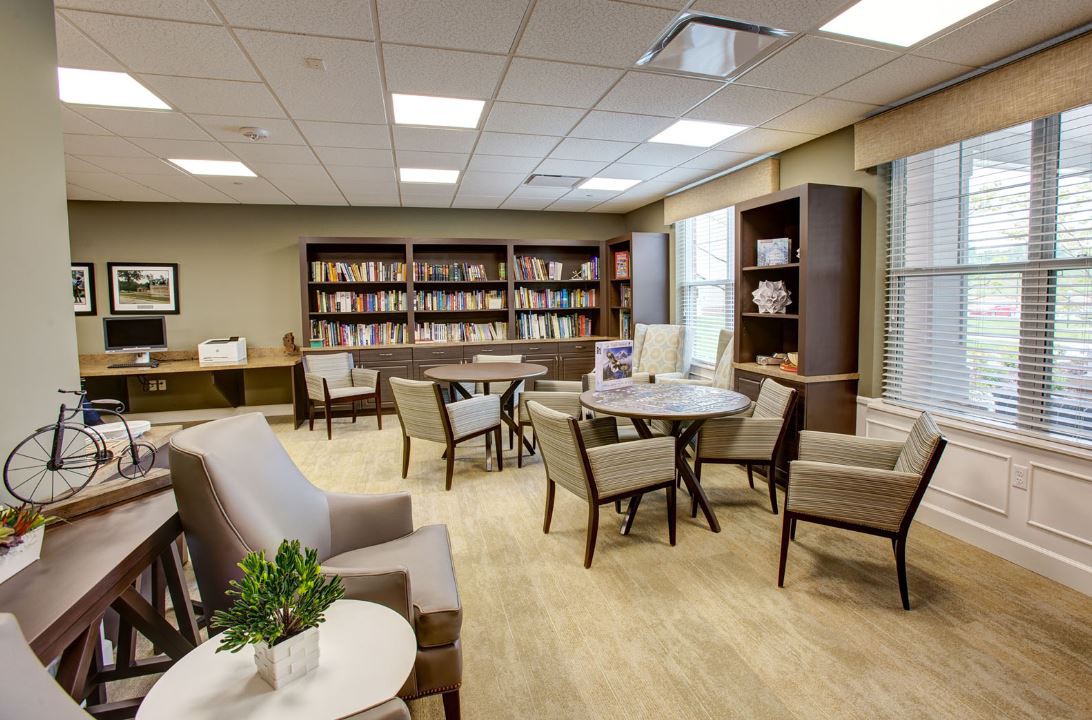 A modern library with comfortable seating and bookshelves lining the walls.
