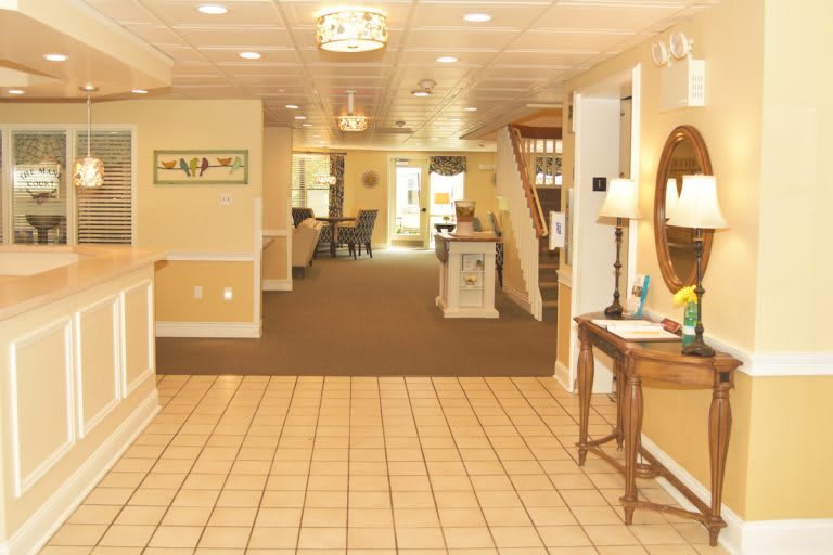 A warmly decorated lobby area with a reception desk and seating.