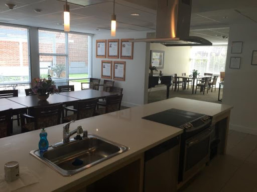 A modern kitchen and dining area featuring a well-equipped cooking space and ample seating.