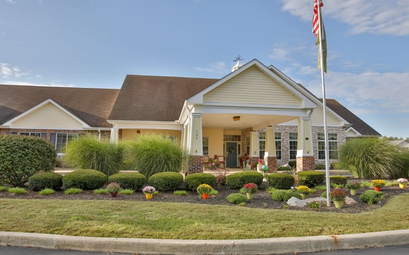 A well-maintained building with a landscaped front yard and flagpole.