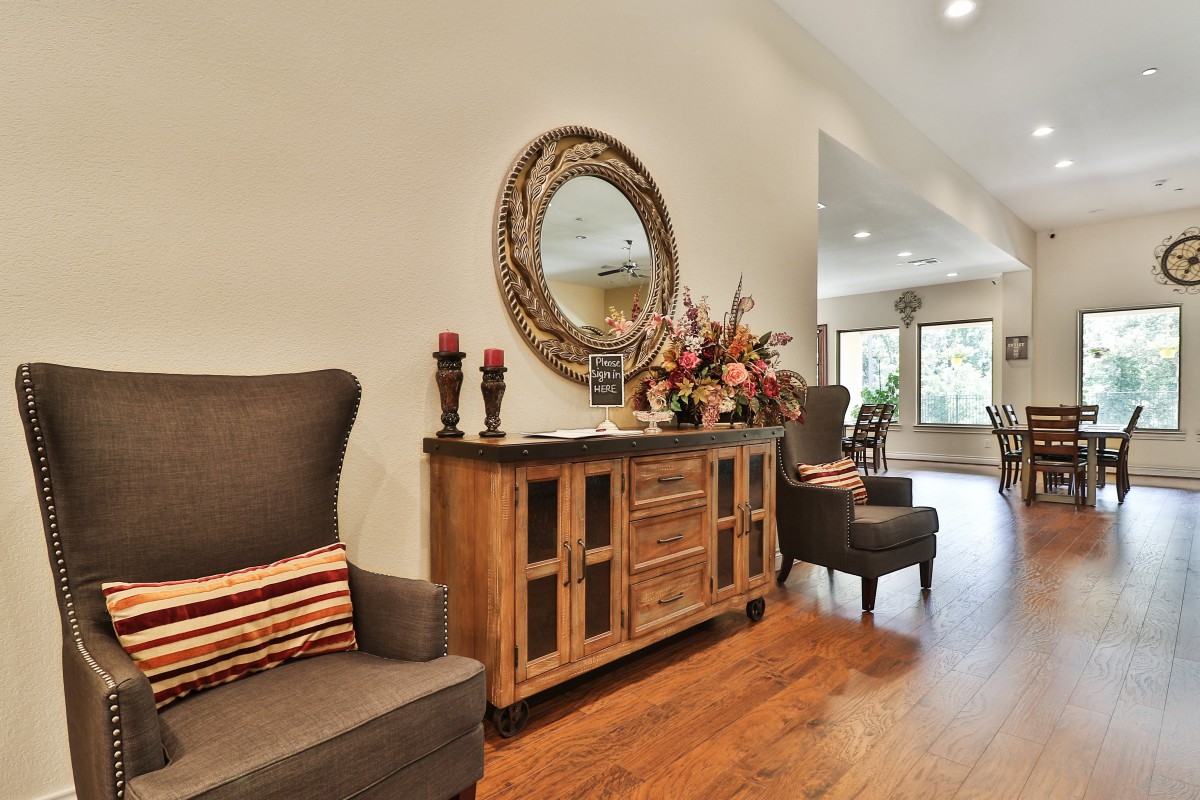 A welcoming living room with elegant wooden furniture and decorative elements.