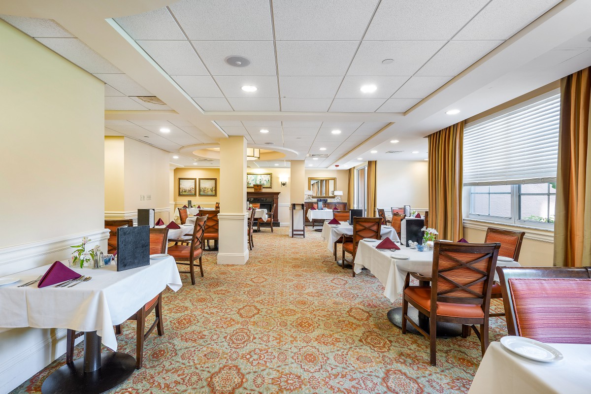 An elegant dining room with neatly arranged tables and chairs.