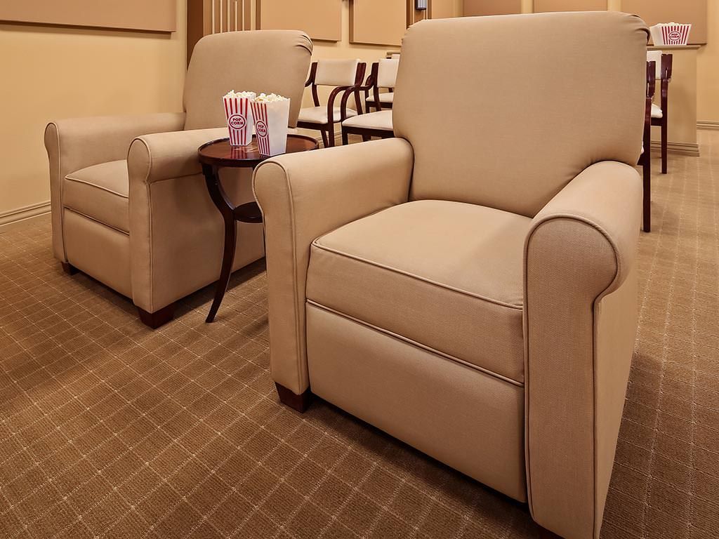 A cozy seating area with beige upholstered chairs and a small coffee table.
