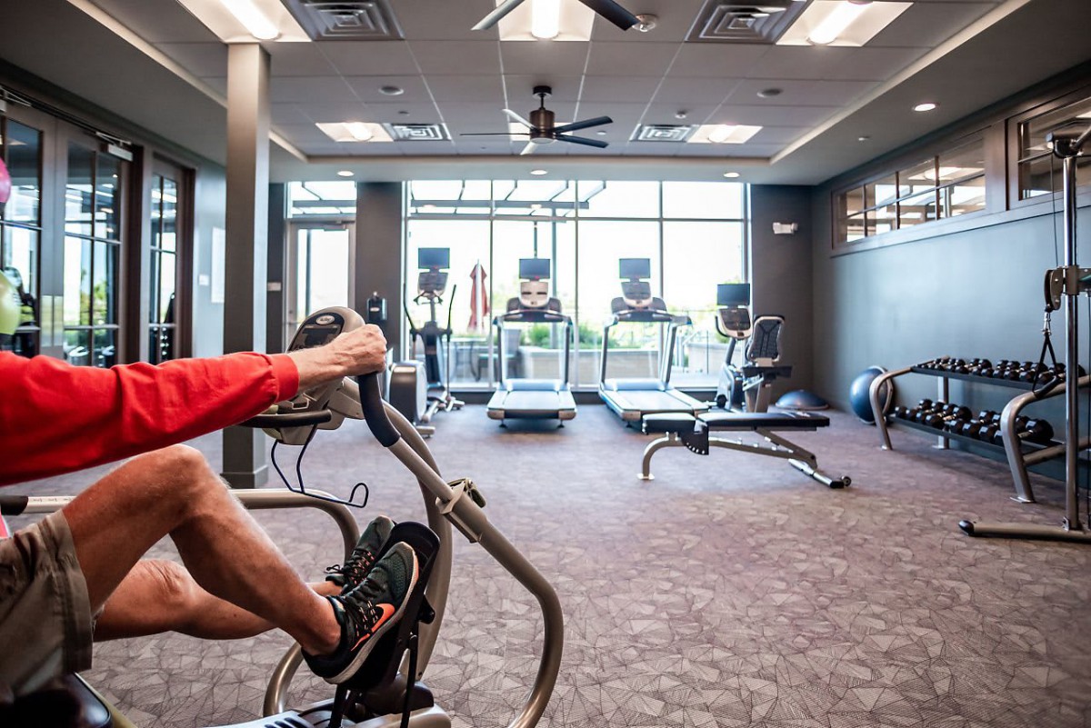 A well-equipped gym with various exercise machines, including stationary bikes and treadmills.