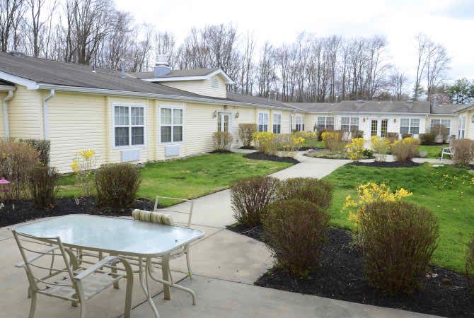 A residential area with a well-maintained garden and outdoor patio seating.
