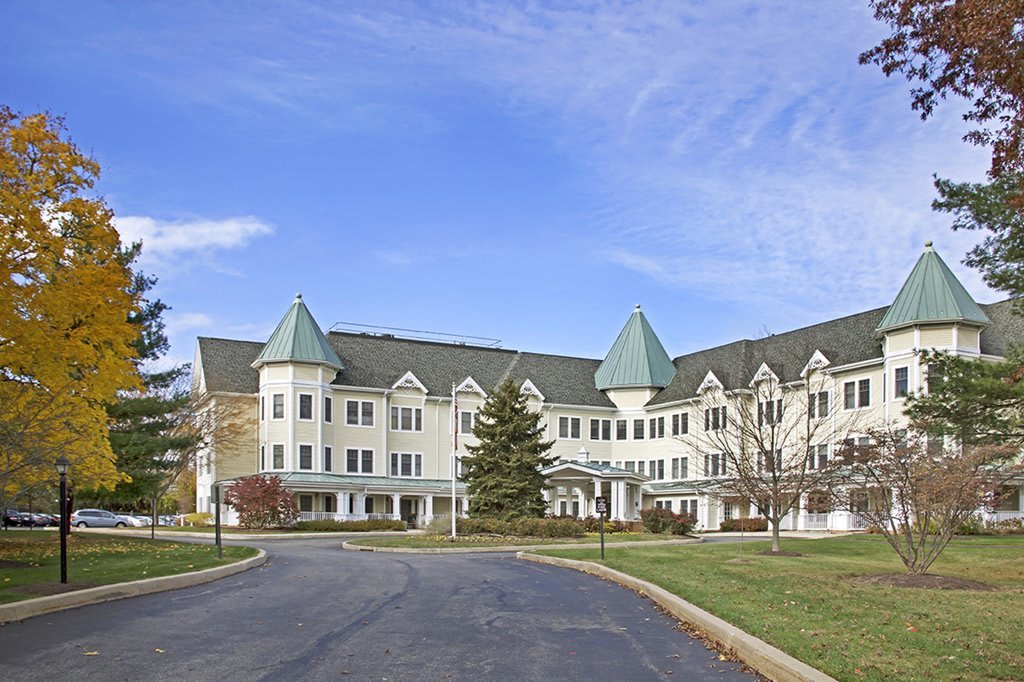 A large residential building with distinct architectural features and a clear sky backdrop.