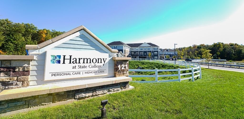 Harmony at State College building with a sign in the foreground.