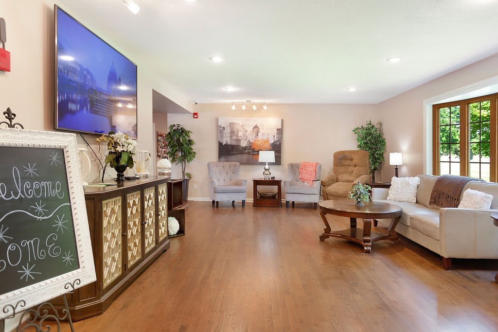 A spacious and elegantly decorated living room with comfortable seating and stylish decor.
