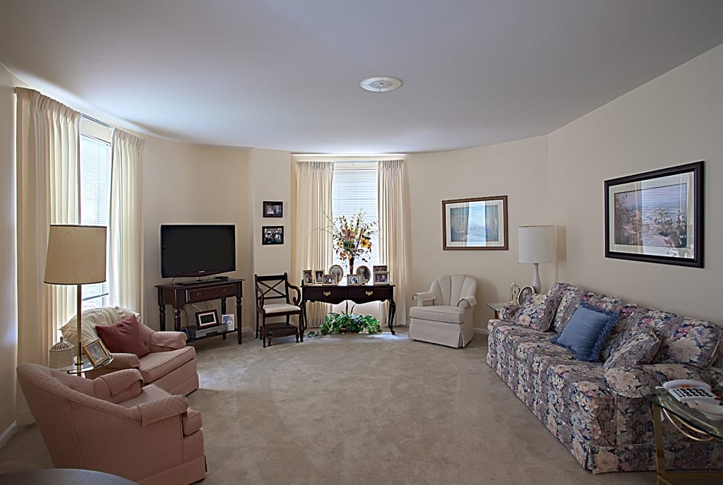 A cozy living room with comfortable seating, a TV, and tasteful decor.