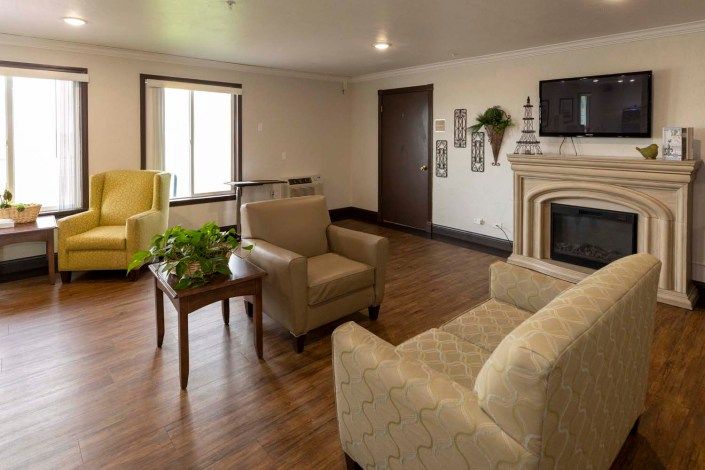 A cozy living room with comfortable seating and a fireplace.