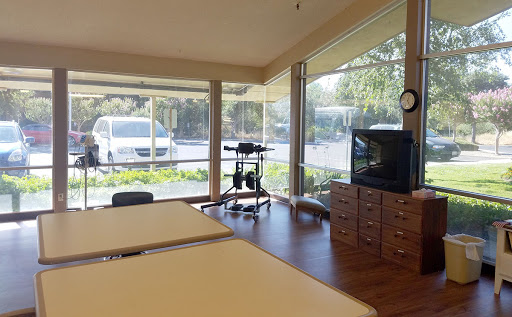 A serene spa interior featuring treatment tables and large windows that invite natural light.