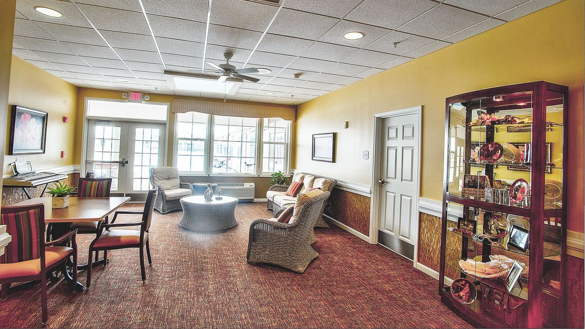 A cozy living room with comfortable seating and large windows.