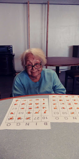 An elderly woman enjoying a game of bingo.
