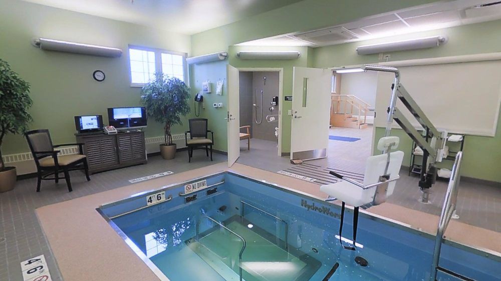 An indoor therapy pool at a rehabilitation facility designed for physical therapy exercises.