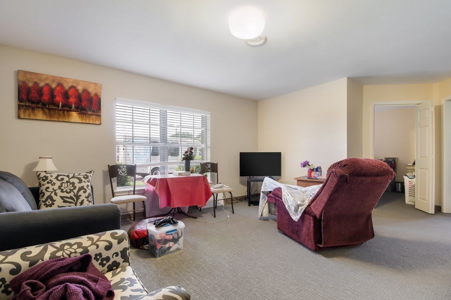 A cozy living room with comfortable seating and a television.