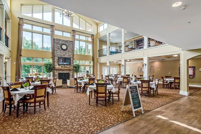 A spacious restaurant with modern decor and large windows offering plenty of natural light.