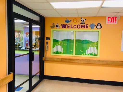 A welcoming entrance to a children's playroom with colorful decorations.