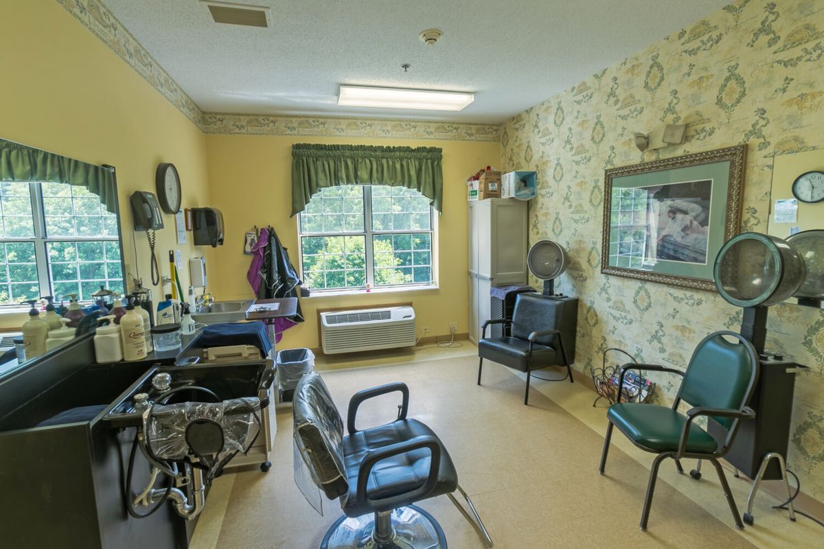 A cozy hair salon with two chairs and a large mirror.