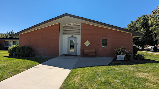 A modern brick building with a welcoming entrance and clear blue skies.