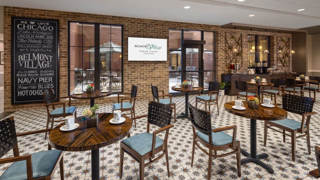 A cozy cafe interior with wooden tables and chairs, against a brick wall backdrop.