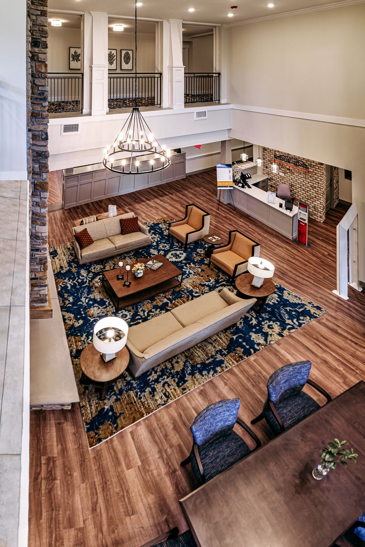 An elegant hotel lobby with a spacious seating area and a large chandelier.