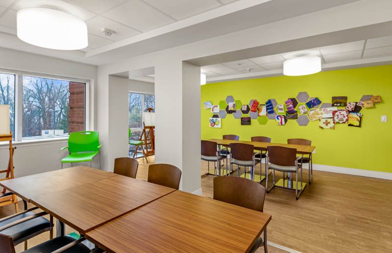 A modern office meeting space with colorful walls and ample seating.