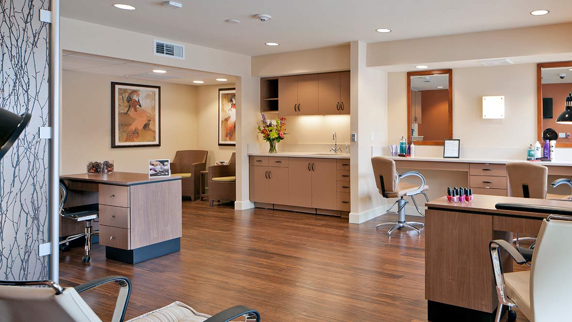 A modern hair salon with stylish furnishings and warm lighting.