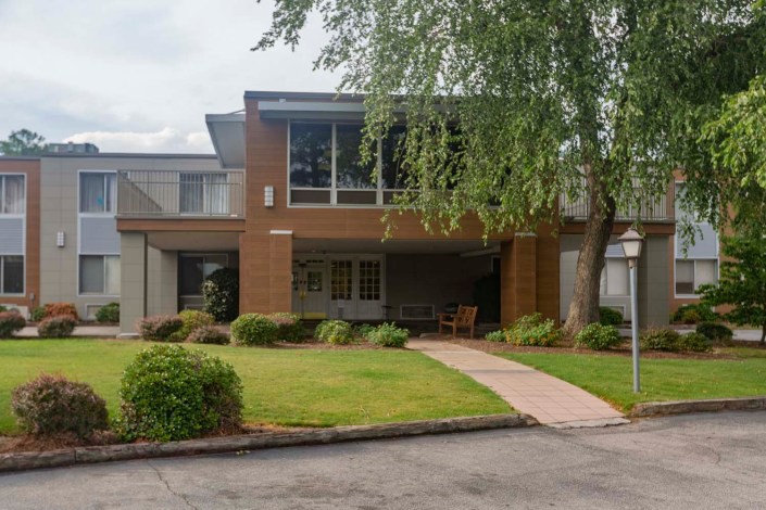 A modern two-story house with a brick exterior and well-maintained landscaping.
