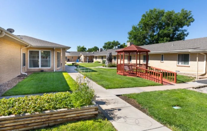 A well-maintained residential courtyard featuring a garden, gazebo, and walkways.