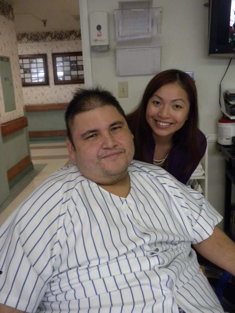 Two people smiling in a hospital setting.