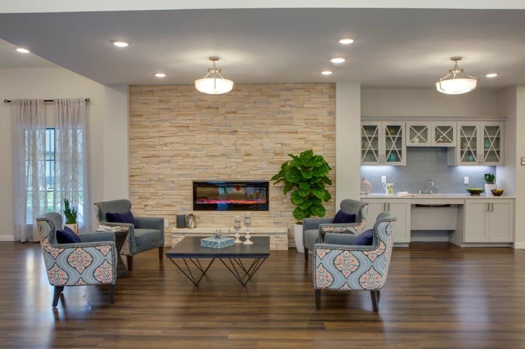 A modern living room with a sleek fireplace, stylish furniture, and contemporary decor.