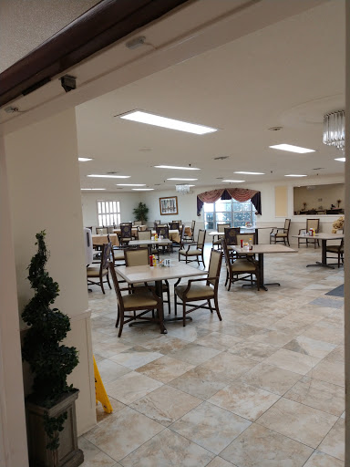 A spacious dining area featuring tables and chairs arranged for customers.