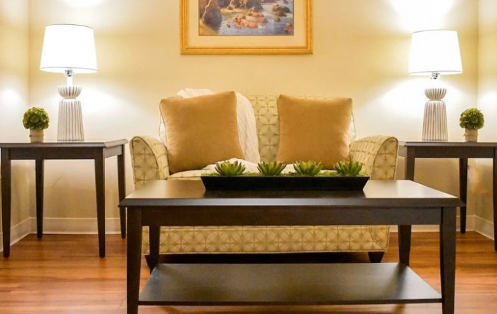 A cozy living room setup with a sofa, coffee table, and ambient lighting.