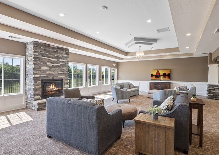 A spacious and modern living room with a fireplace and comfortable seating arrangement.