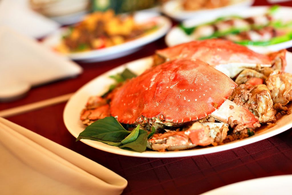 A deliciously prepared crab served on a plate, ready to be enjoyed.