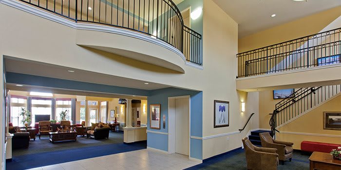 Modern lobby area with stairs and elevator.
