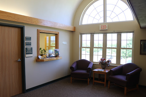 A bright and welcoming waiting area with comfortable seating and large windows.