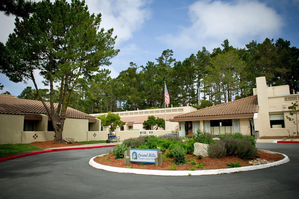 A healthcare facility surrounded by trees and natural scenery.