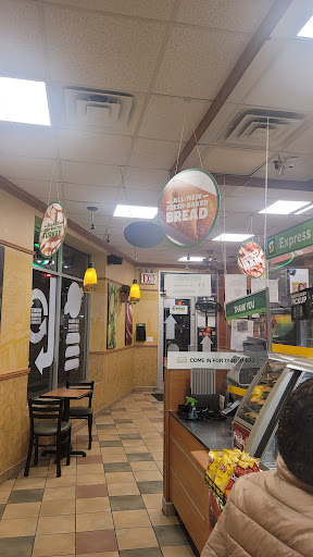 Interior view of a fast food restaurant showcasing the dining area and menu signage.