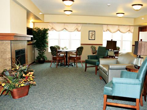 A cozy living room with seating area and fireplace.