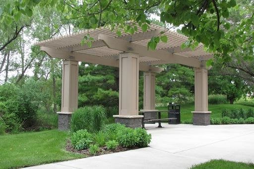 A gazebo in a peaceful park surrounded by lush greenery.
