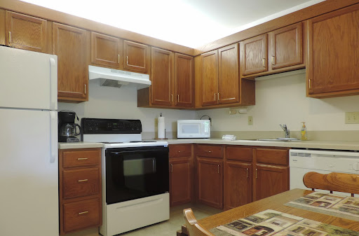 A well-organized kitchen featuring wooden cabinets and essential appliances.