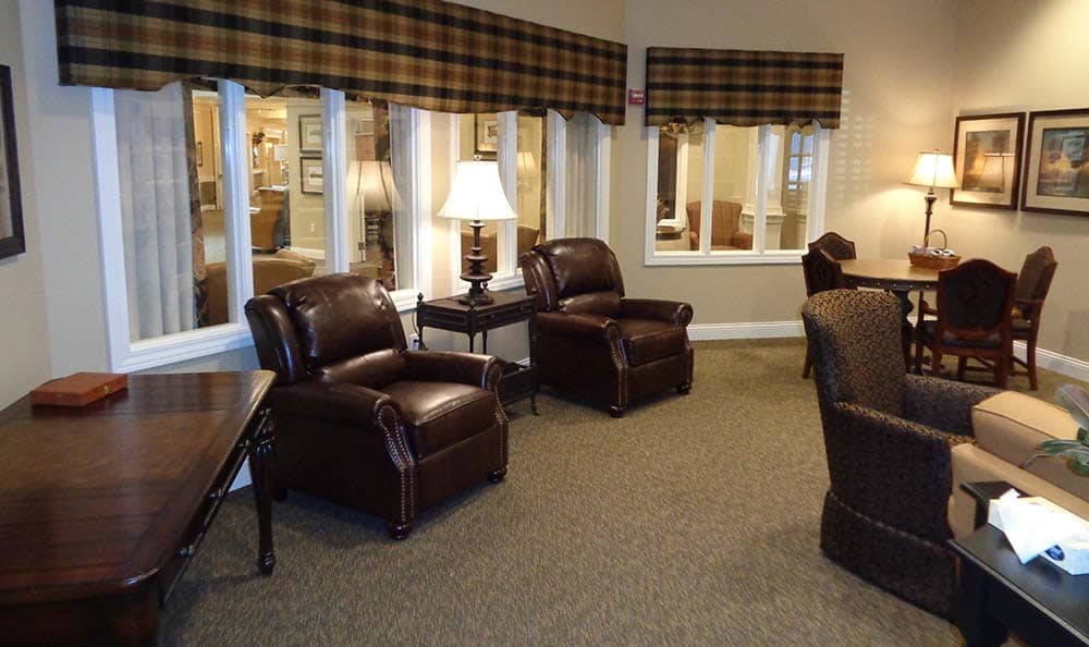 A cozy living room with leather chairs and soft lighting.
