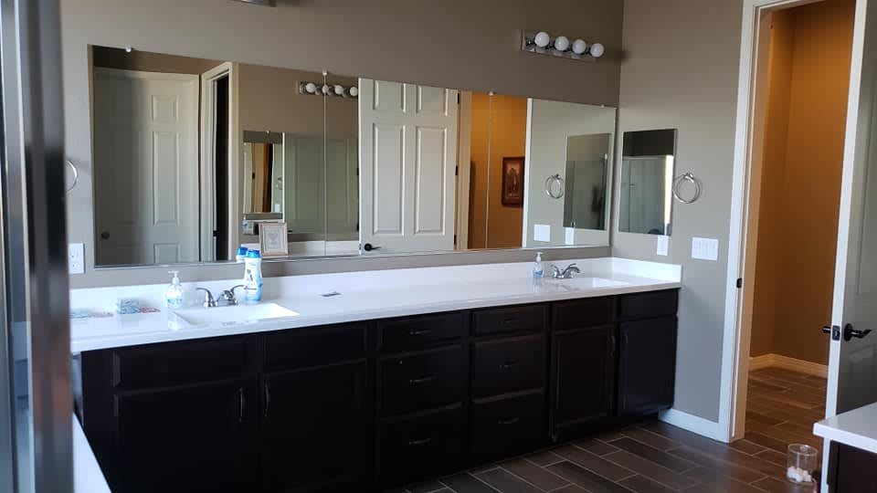Spacious bathroom with a large mirror and double sinks.
