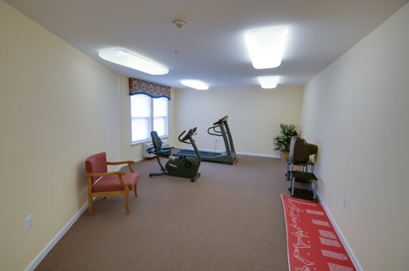 A small exercise room featuring a treadmill and a stationary bike.
