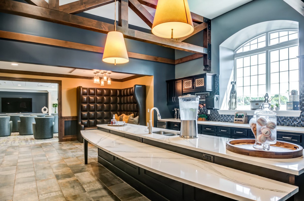 A spacious modern kitchen with an island counter and elegant pendant lighting.